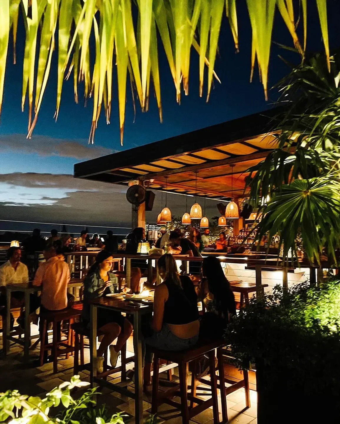 Rooftop dining at Astra Miami restaurant, with a beautiful evening ambiance.