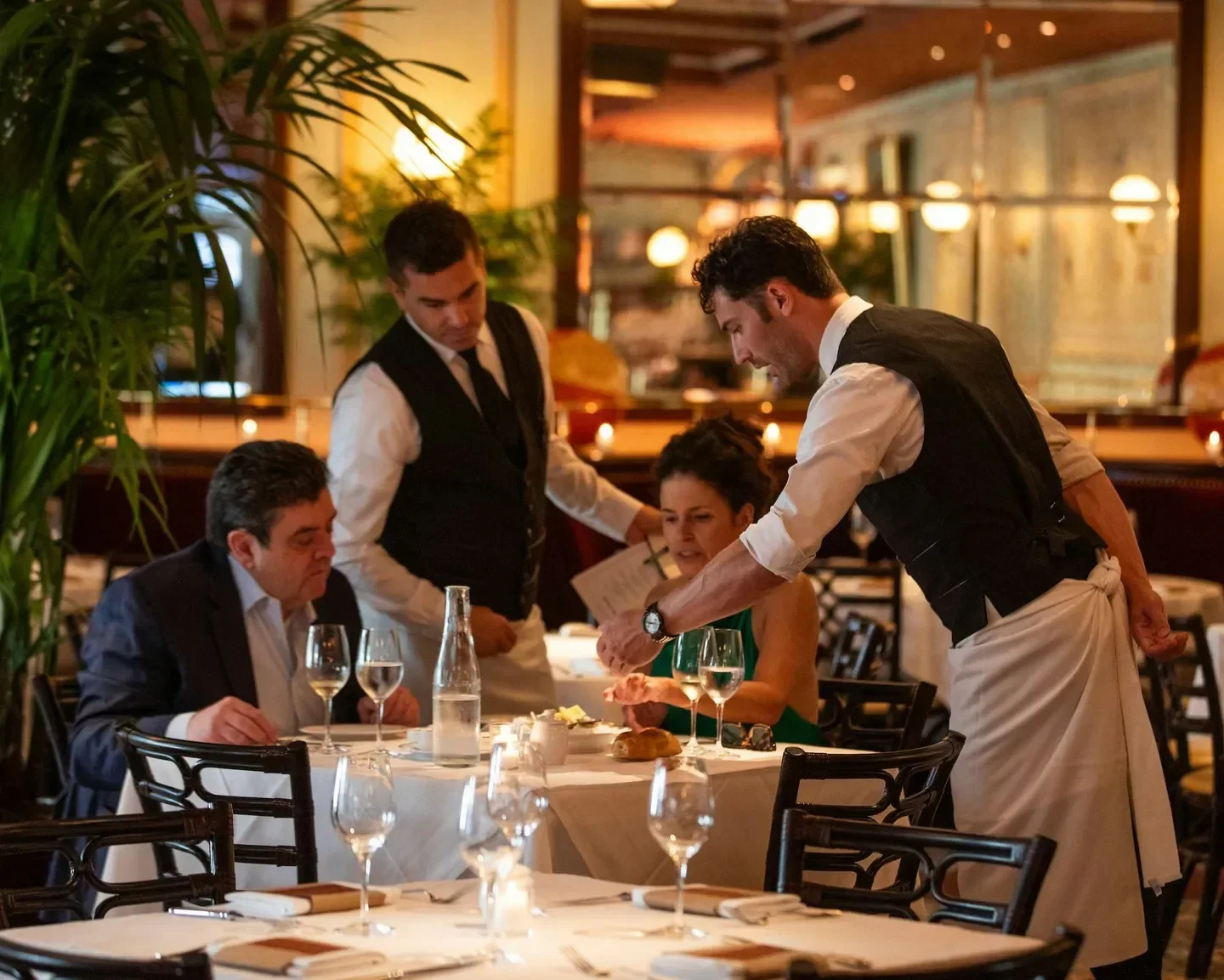 Bouchon Bistro - Coral Gables in Miami: Waiter serving diners in a classic restaurant.