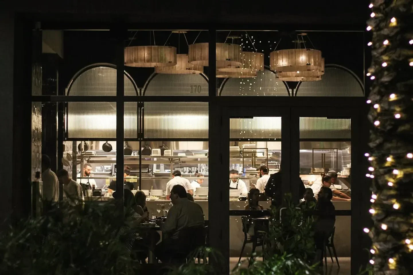 Night view of the open kitchen and dining area at Brasserie Laurel in Miami.