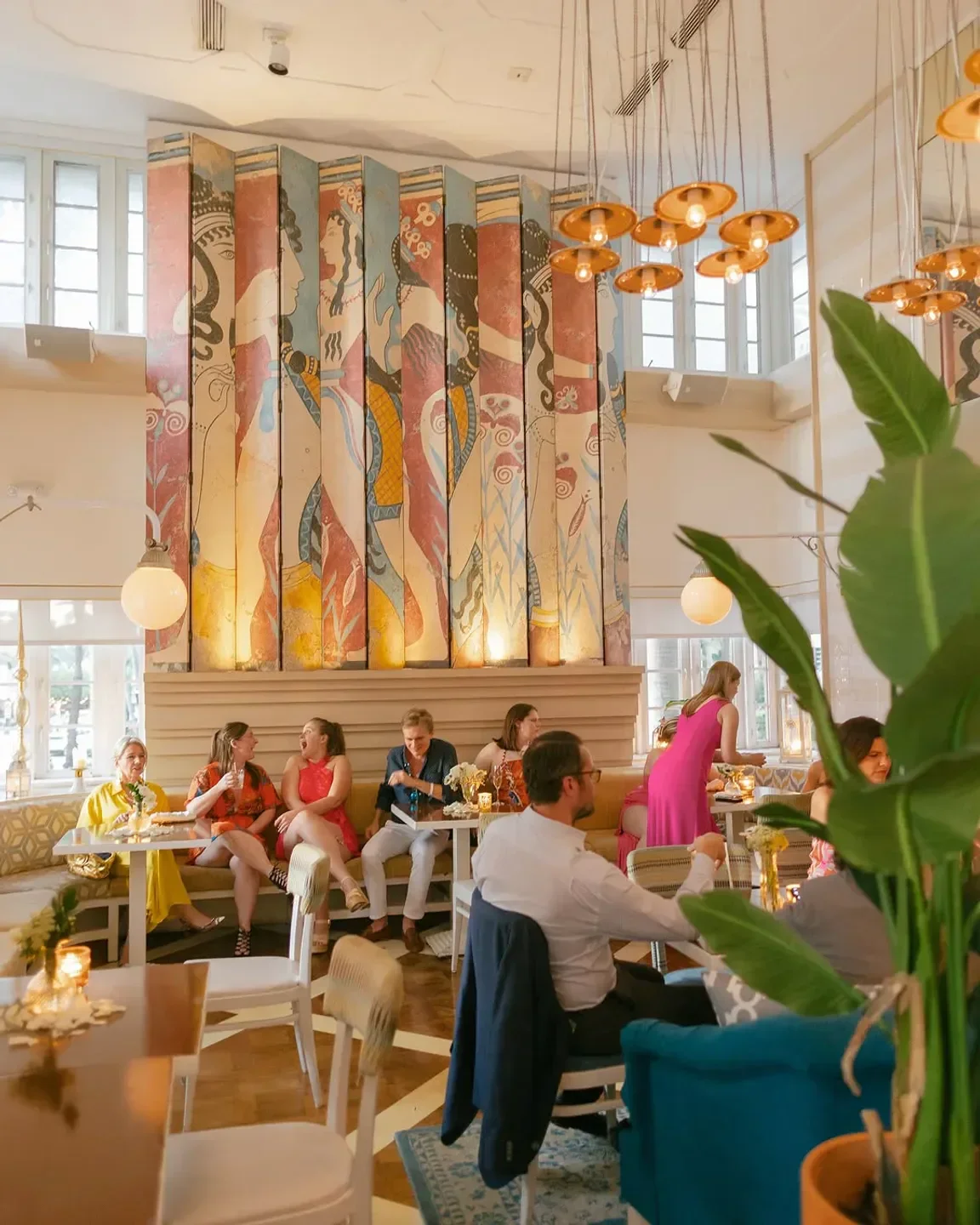 Byblos Miami restaurant interior with artwork and people dining in a stylish setting.