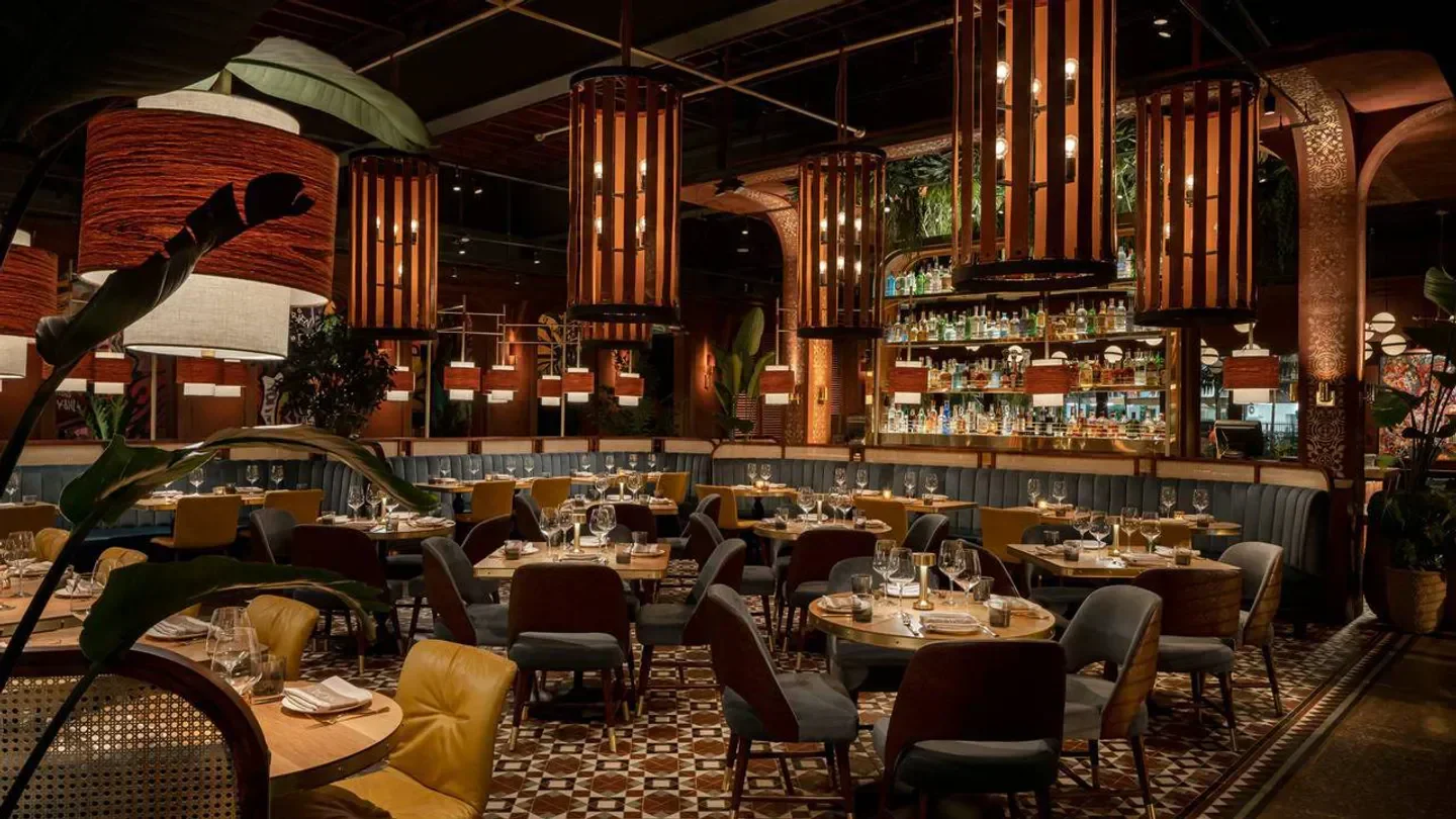 Chica Miami restaurant interior with stylish decor, chandeliers and elegant dining tables.