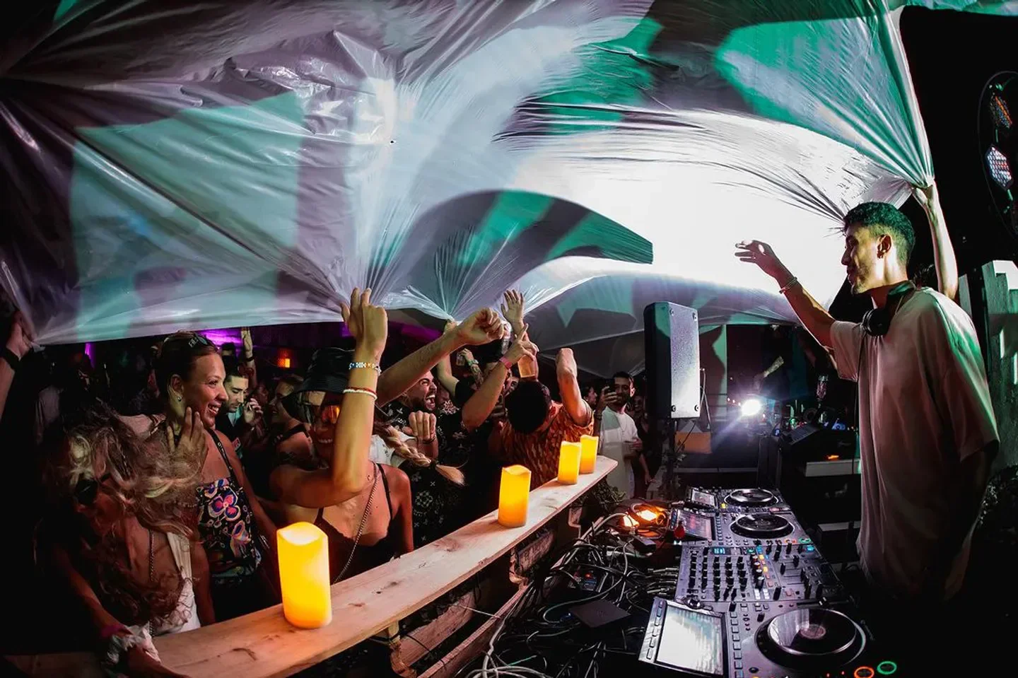 Clevelander Miami Beach Club party with DJ and crowd, under a translucent canopy