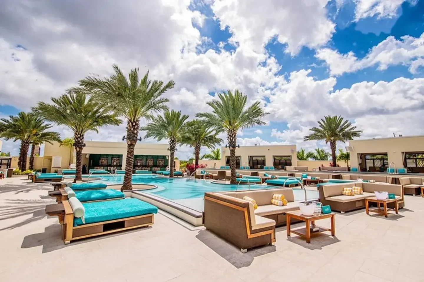 Lounge seating and pool at DAER Dayclub in Miami, Florida under a blue sky.