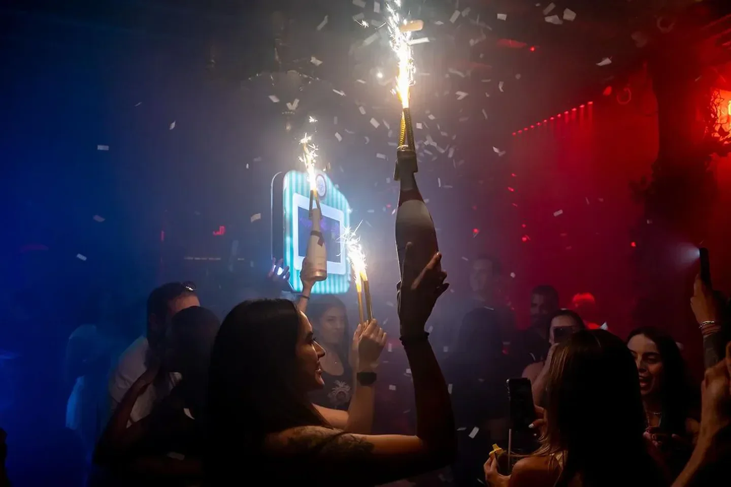 Celebration at El Patio Wynwood nightclub in Miami with fireworks and partygoers.