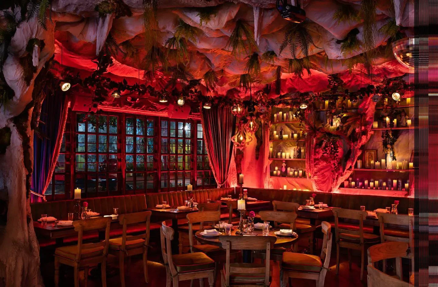 Interior of El Santo restaurant in Miami, with red lighting and unique cave-like ceiling