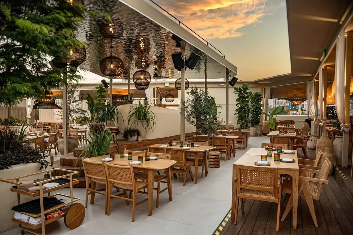 Rooftop dining at Fabel Miami restaurant with sunset views and stylish decor.
