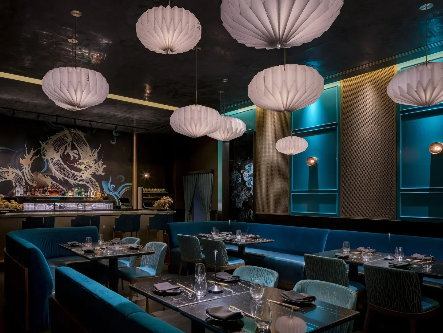 Interior of Gekkō Miami, featuring stylish seating, paper lanterns, and a dragon mural.