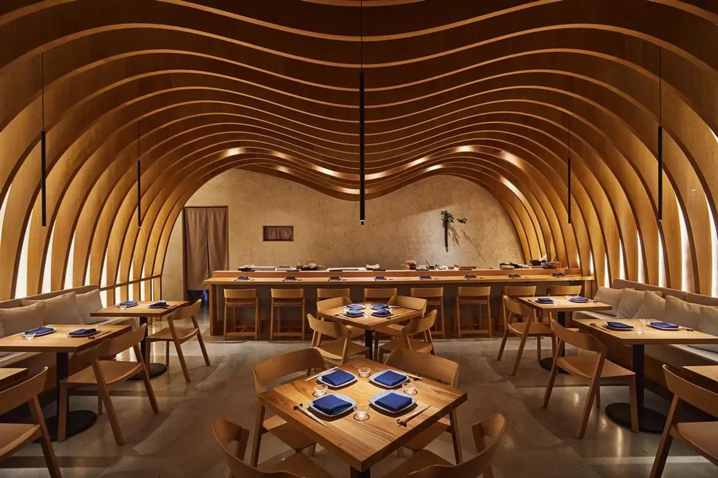 Interior of Hiyakawa Miami, with wooden archway and tables set for dining.