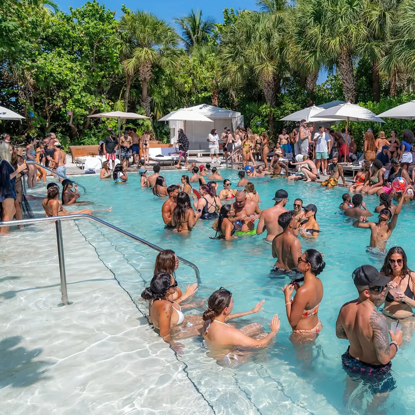 Pool party at Hyde Beach in Miami, people enjoying the pool in the sun.