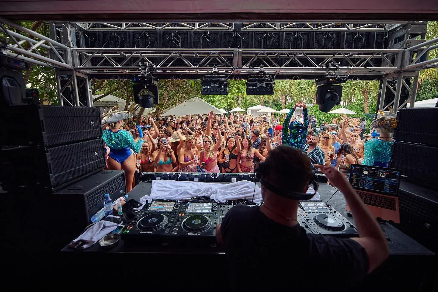 DJ playing at Hyde South Beach in Miami, lively beach club scene with a crowd.