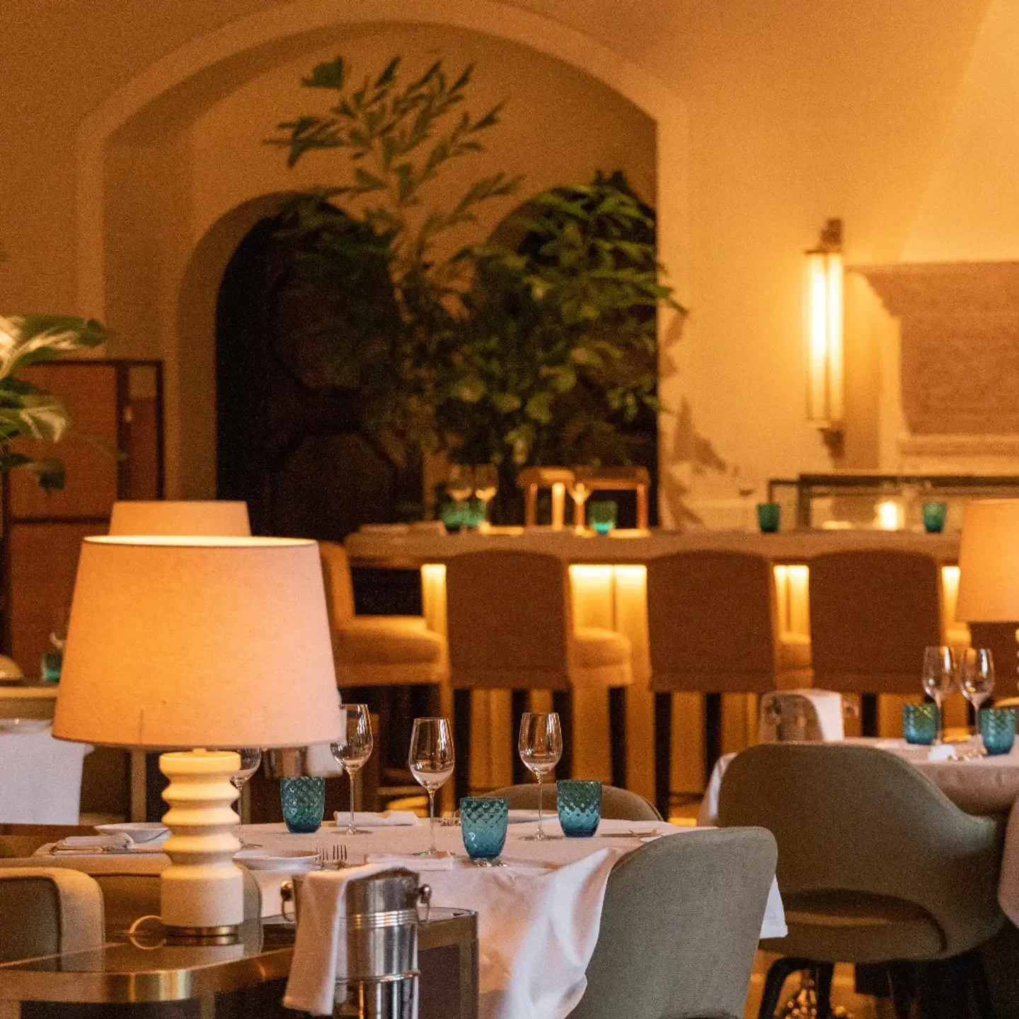 Elegant dining at Lido at The Surf Club in Miami, featuring table settings and bar.