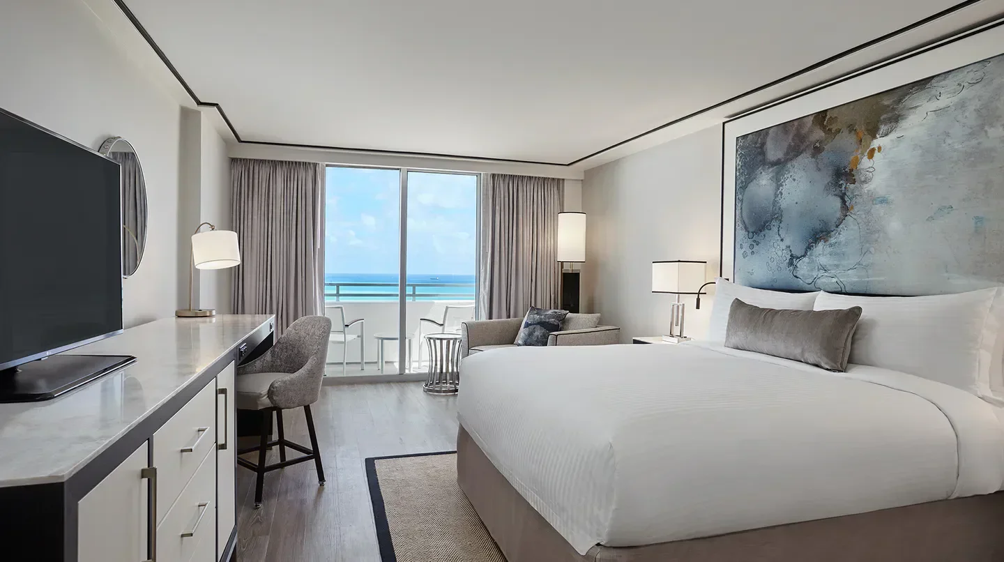 Spacious bedroom at the Loews Miami Beach Hotel in Miami, with ocean views from the balcony.
