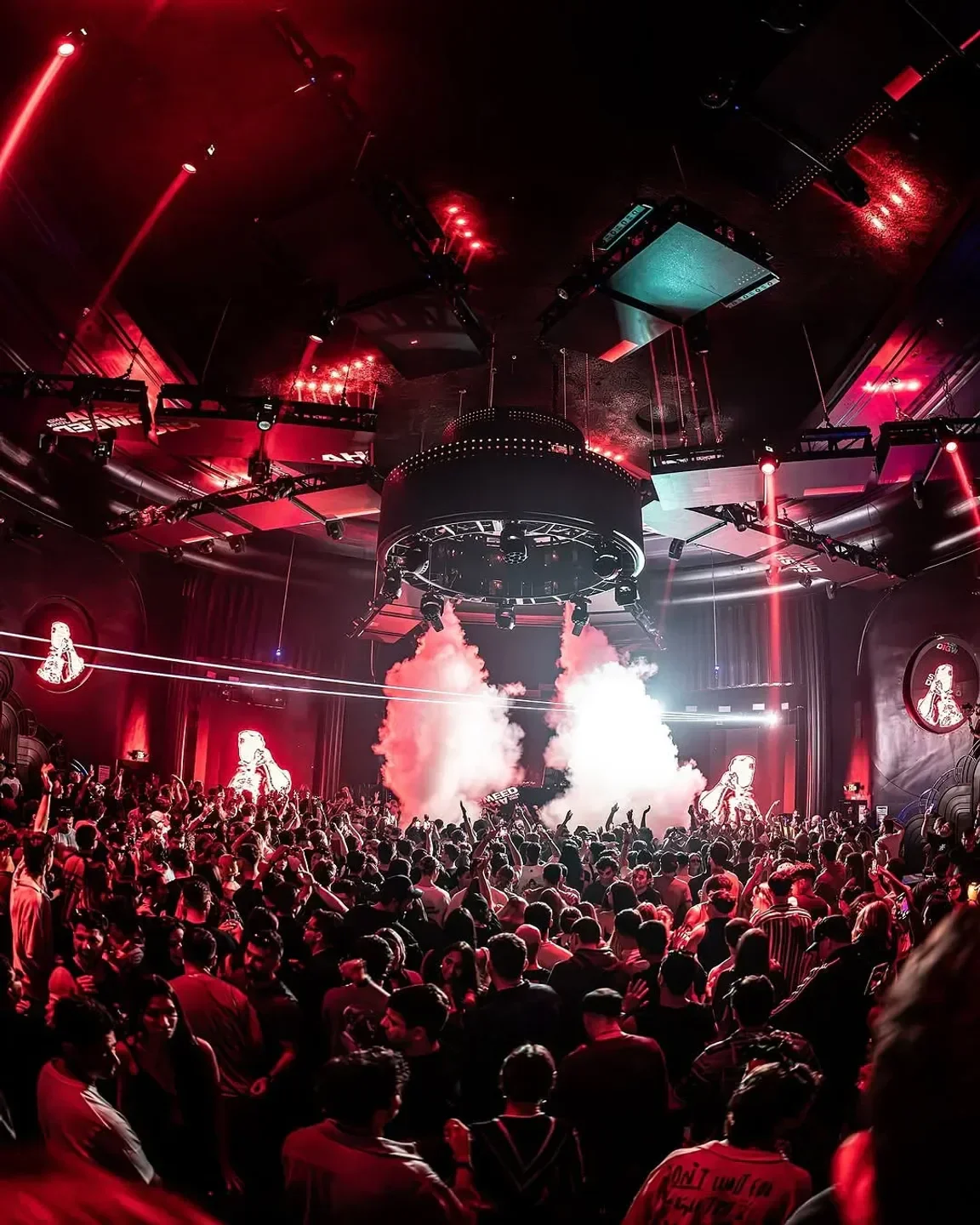 Energetic crowd at M2 Nightclub in Miami, with red lights and smoke effects.