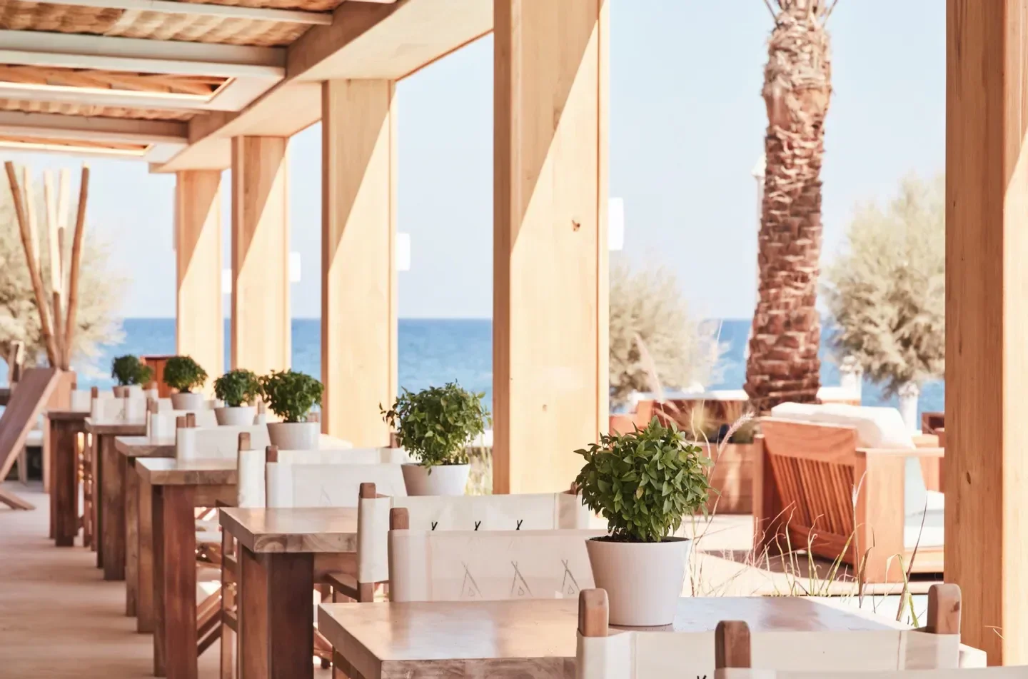 Coastal dining at Nikki Beach Miami with ocean views and stylish wooden decor.