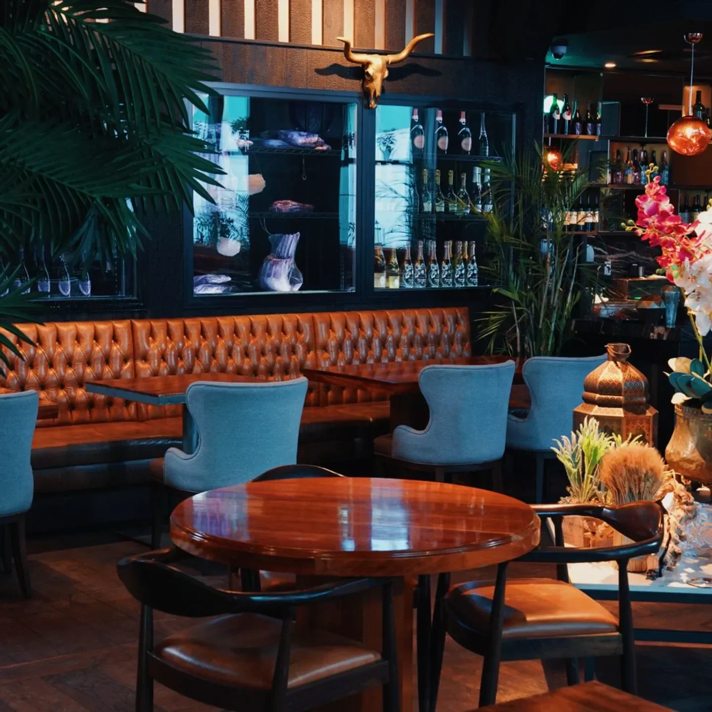 Interior of Nusr-Et Steakhouse in Miami, featuring elegant seating and a curated wine display.