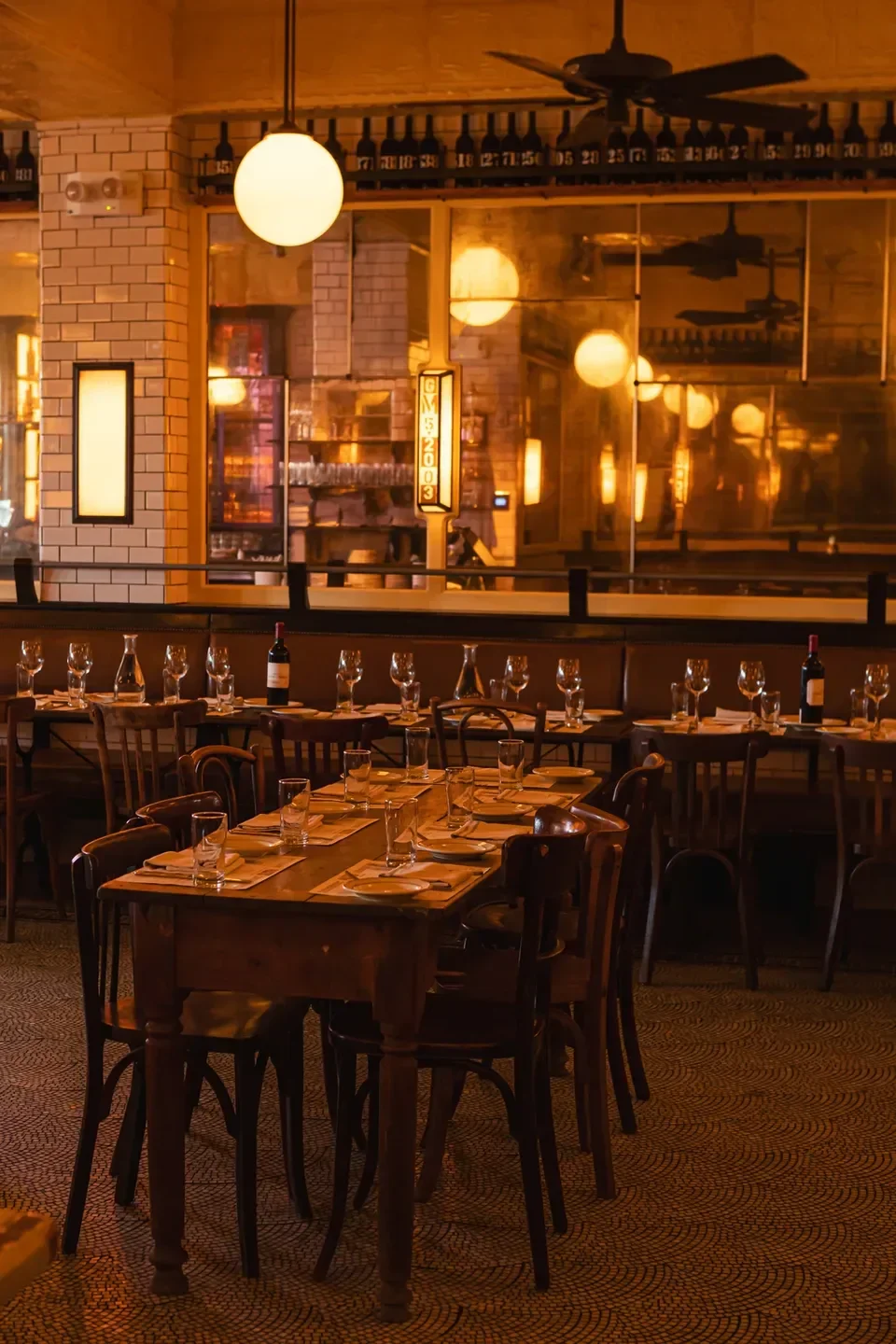Cozy dining room at Pastis Miami, a restaurant in Miami, with tables set.