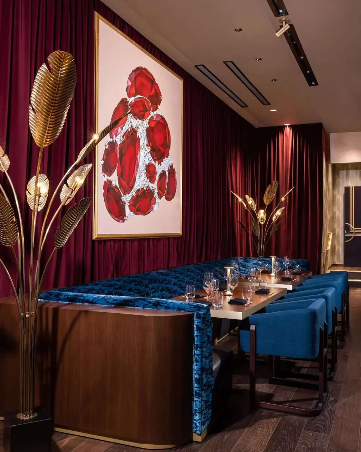 Queen Miami's elegant dining room with stylish art, velvet seating, and Miami ambiance.
