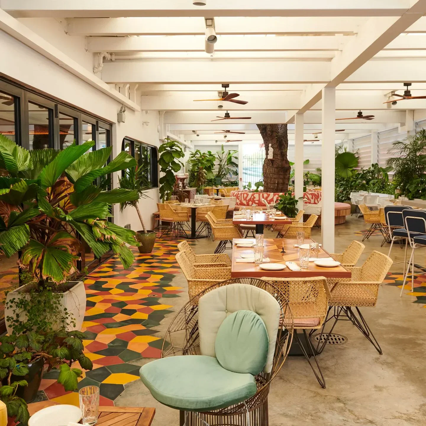 Stylish interior dining at Red Rooster - Overtown in Miami with colorful flooring and plants