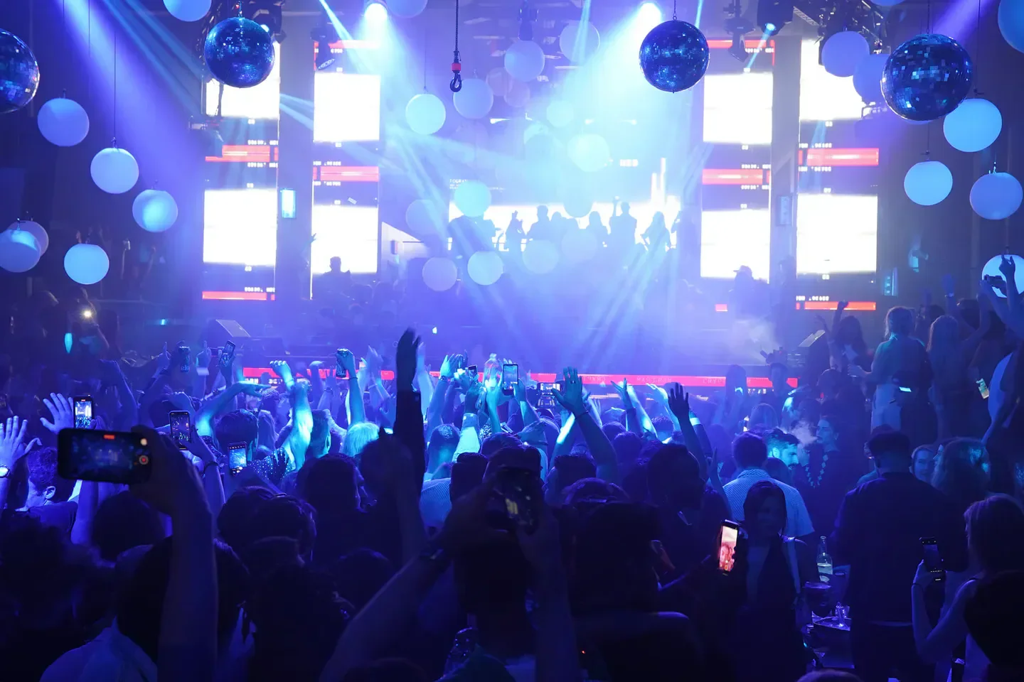 Nightclub scene at Story in Miami, with crowd and blue lighting.
