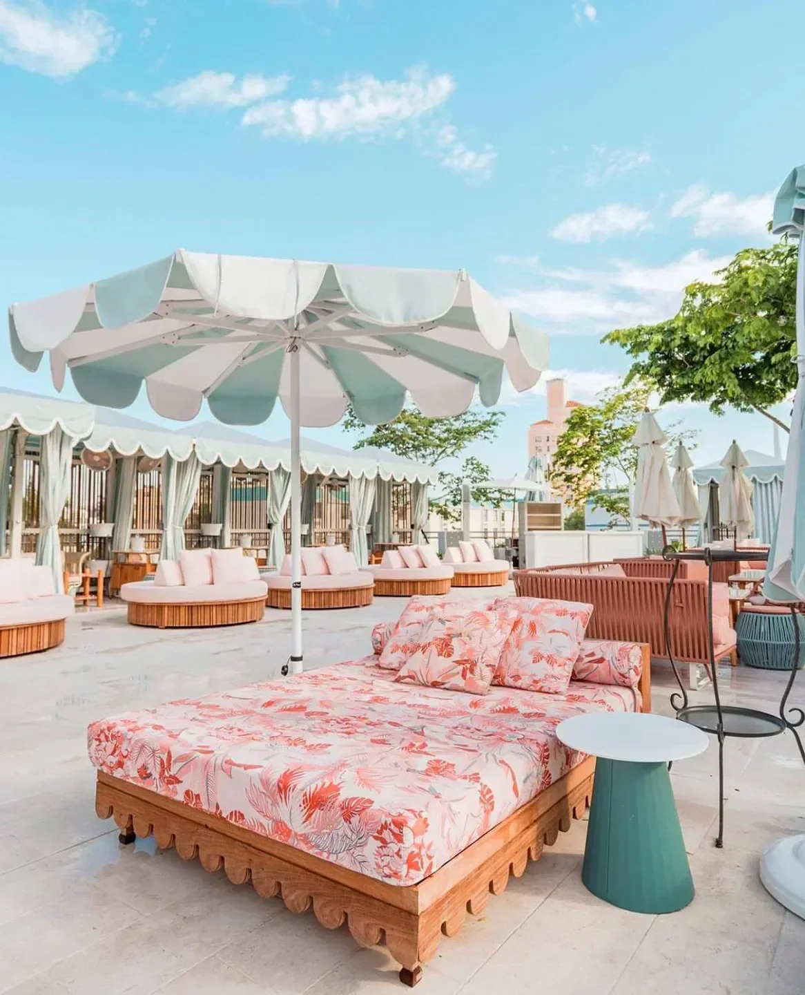 Strawberry Moon beach club in Miami with stylish daybeds and elegant decor under a sunny sky.