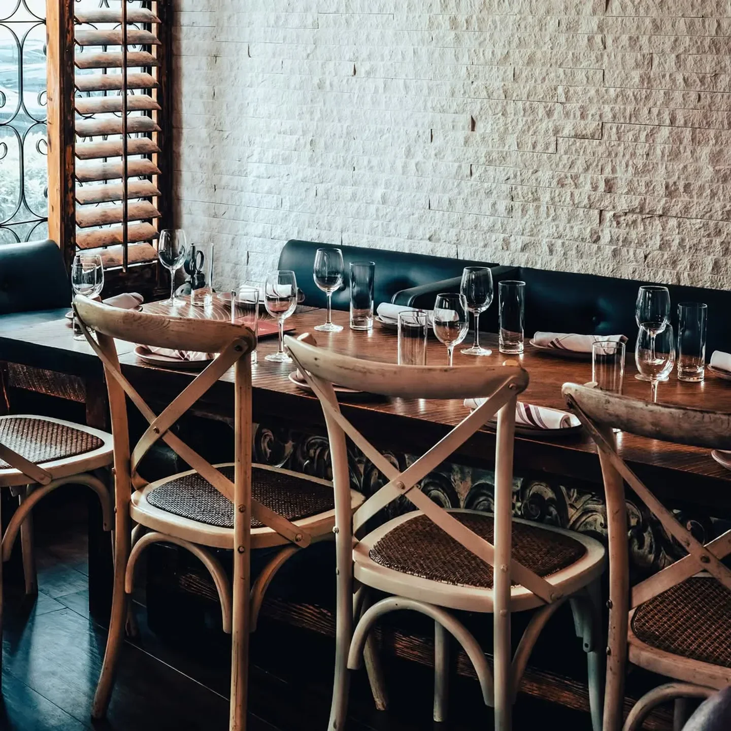 Elegant dining space at SUGARCANE Raw Bar Grill in Miami, with wooden tables and chairs.
