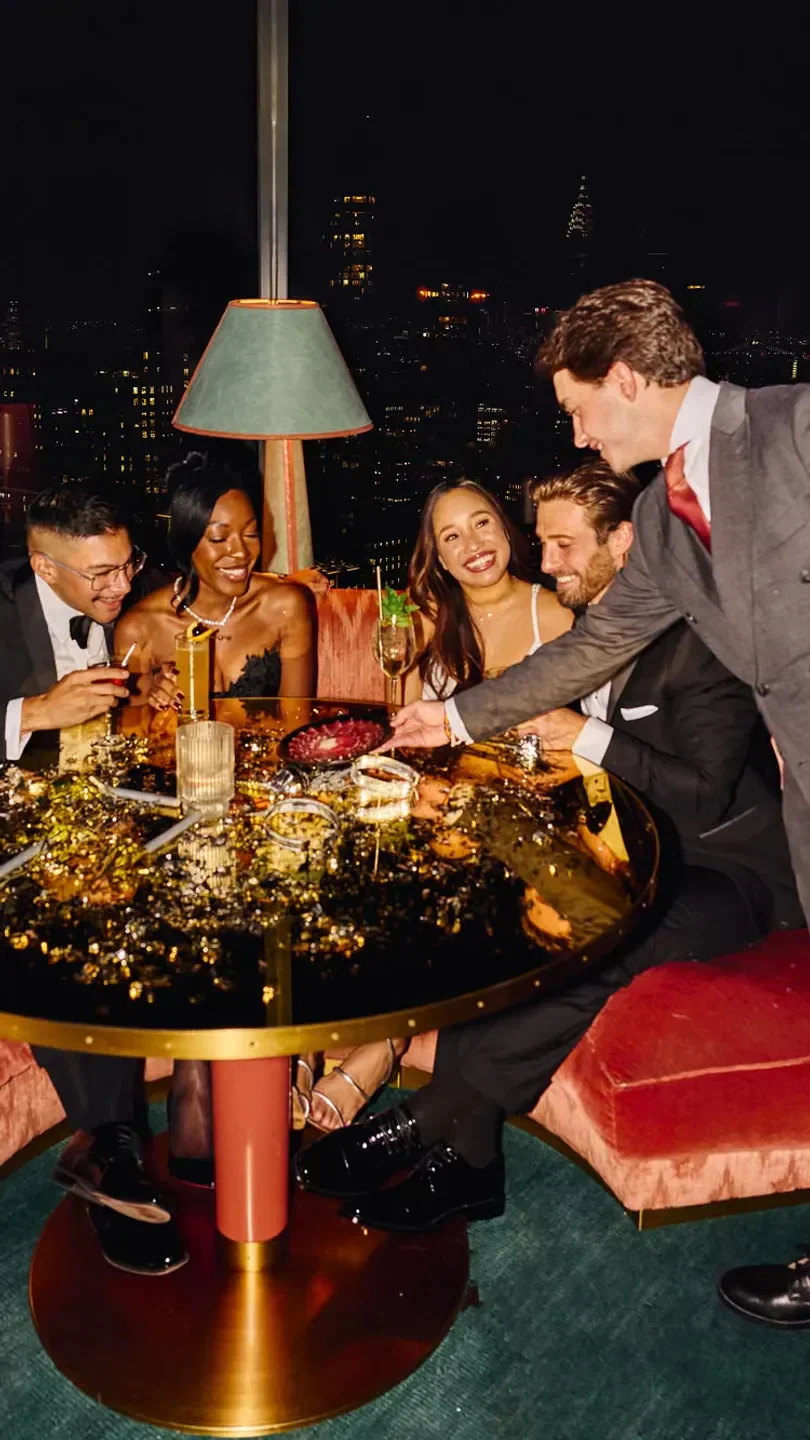 Group enjoying cocktails at The Bazaar by Jose Andres in Miami, with city view