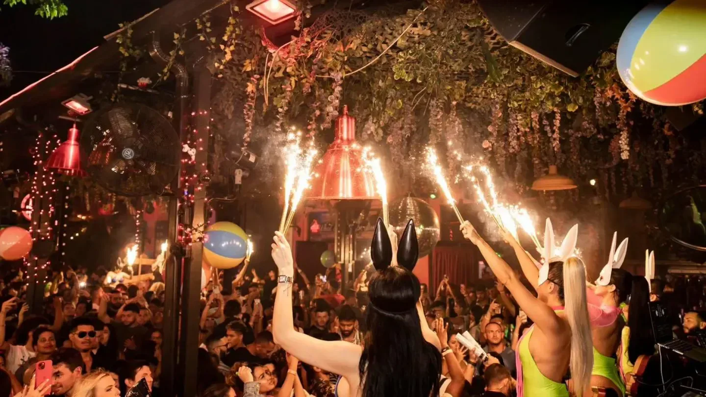 Party scene at The Dirty Rabbit Wynwood nightclub in Miami, with sparklers and crowd.