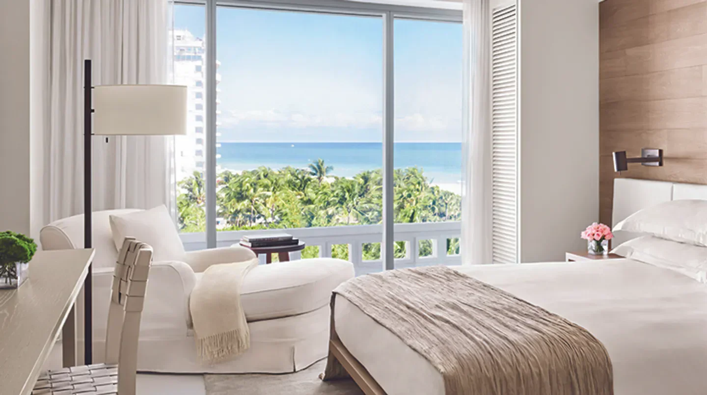 Bright bedroom with ocean view at The Miami Beach EDITION in Miami, Florida.
