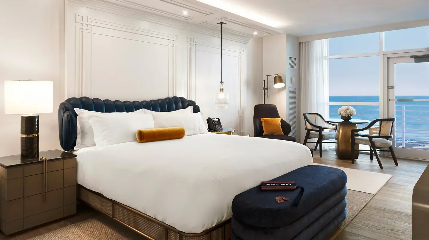 Luxury bedroom at The Ritz-Carlton, South Beach, Miami, with ocean views and stylish decor.