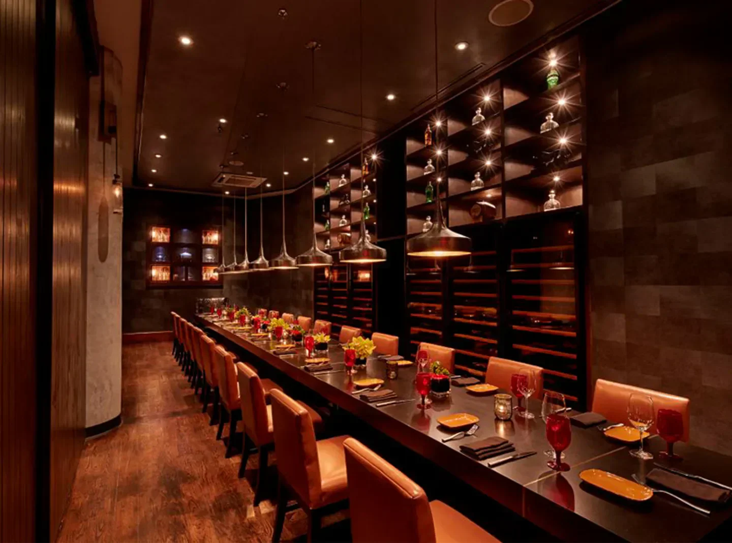 Elegant dining at Toro Toro - Miami, with wine display and long table in Miami restaurant.