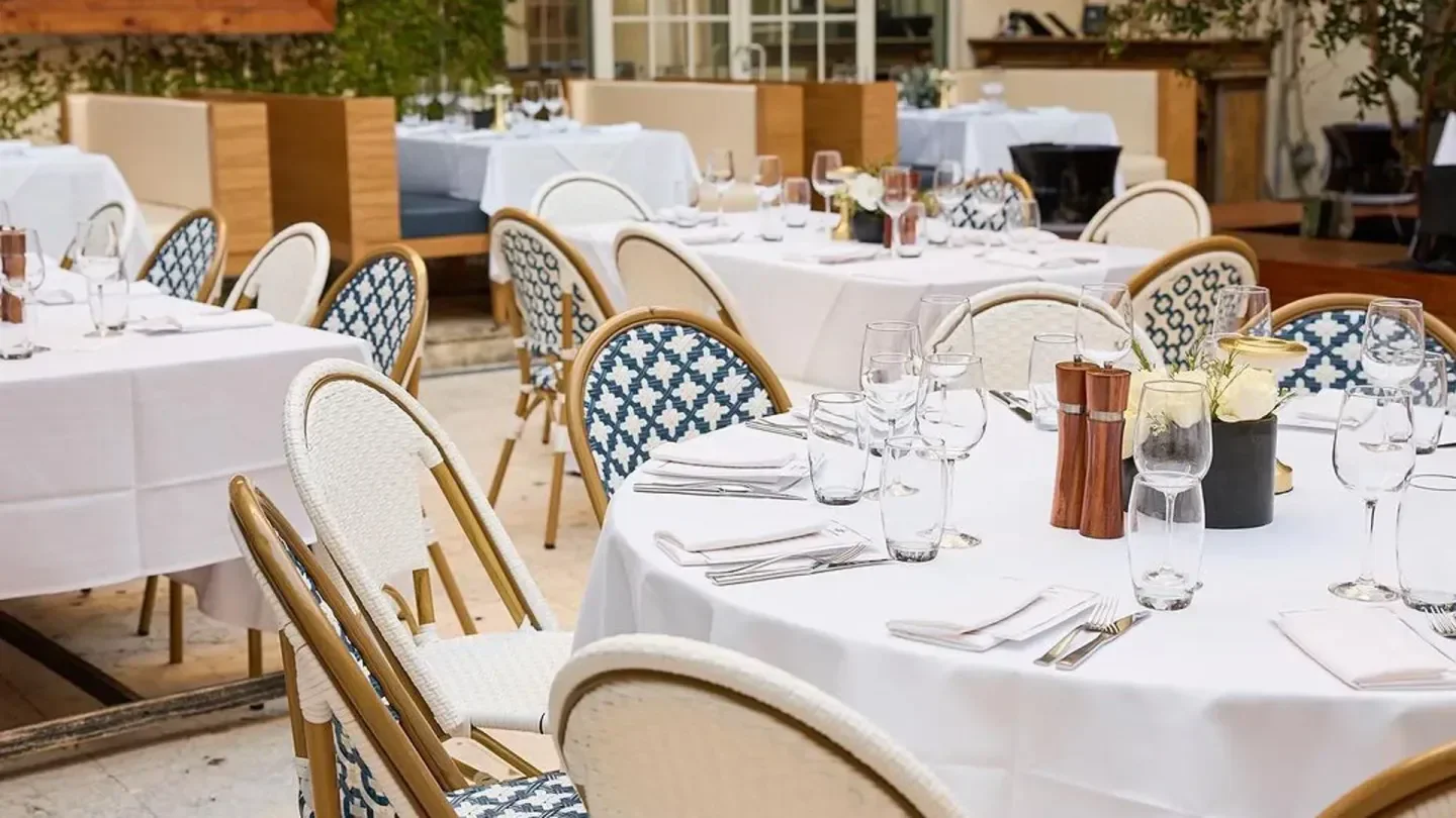 Elegant dining tables at Villa Azur restaurant in Miami, ready for a delightful meal.